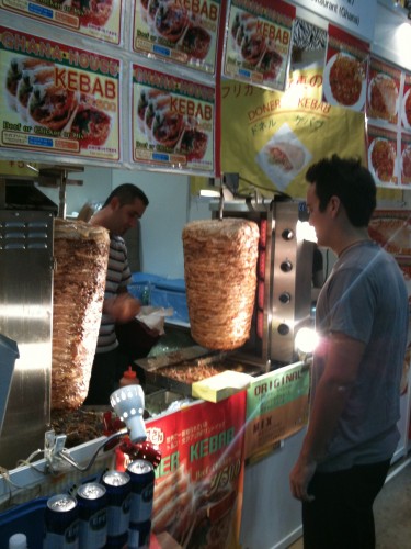 Alex at our favorite Ghana food booth - check out the meat "towers"!
